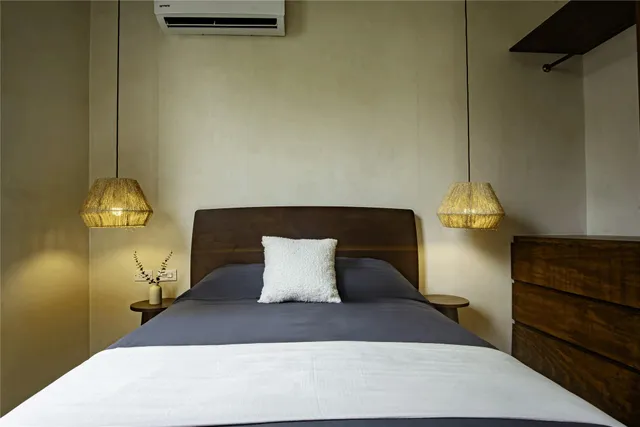 a bed sitting in a room next to a window