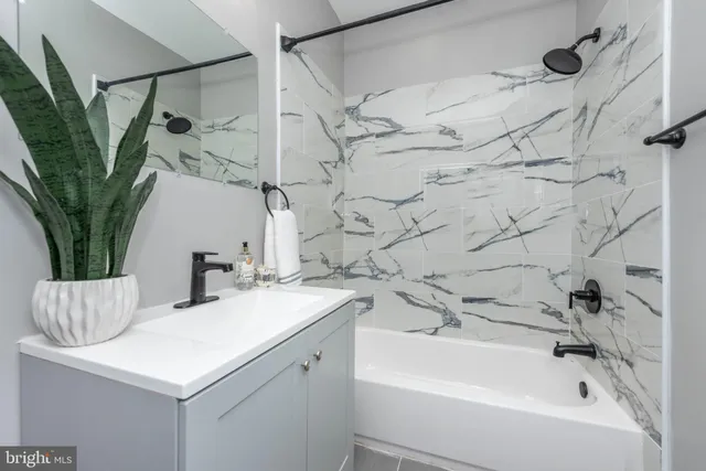 a bathroom with a sink a mirror and a bathtub