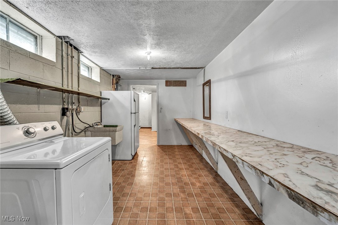 38814 Johnnycake Ridge Road Willoughby, OH 44094 - Photo 36 of 48 Washroom with washer / clothes dryer and a textured ceiling
