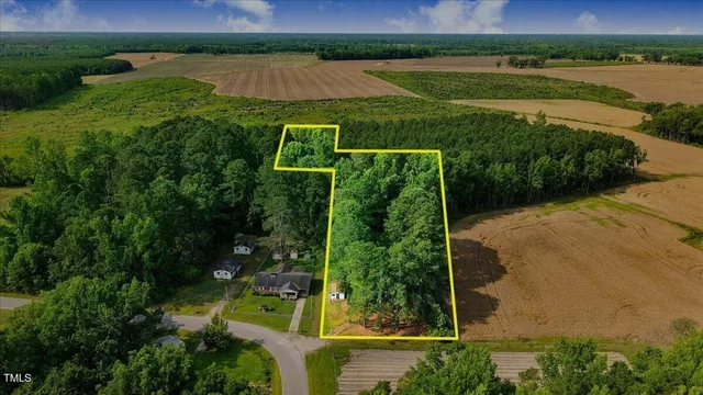 an aerial view of a house with a yard and outdoor seating
