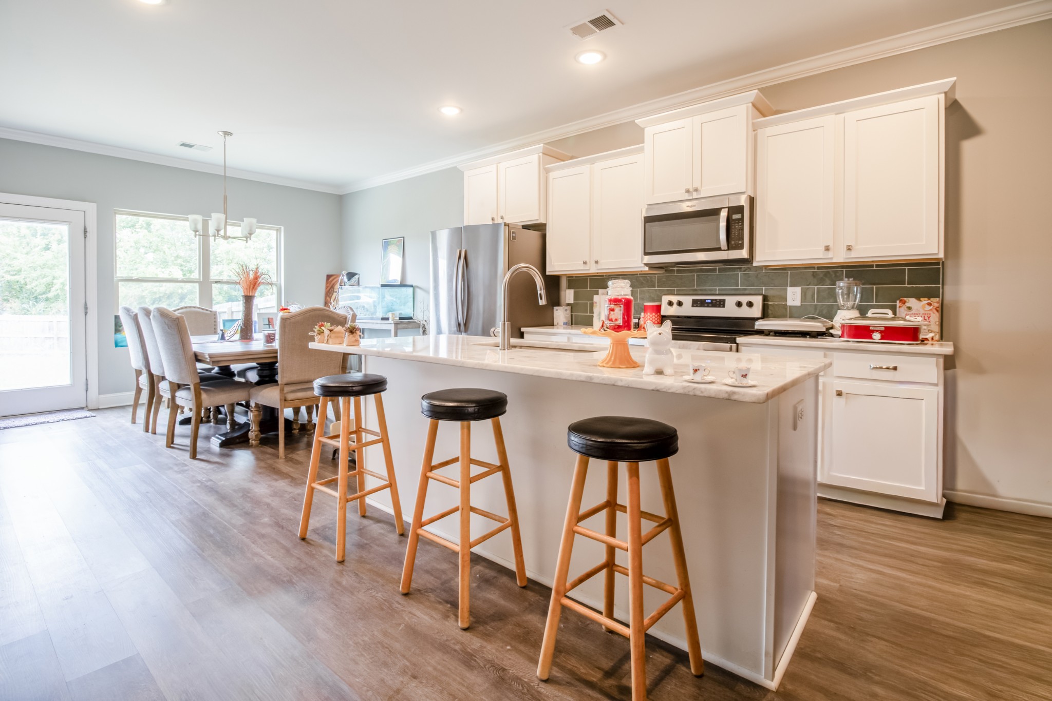 628 Bella Court Lebanon, TN 37087 - Photo 19 of 56 a kitchen with stainless steel appliances kitchen island granite countertop a dining table chairs and granite counter tops