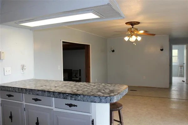 a kitchen with granite countertop a refrigerator and a sink