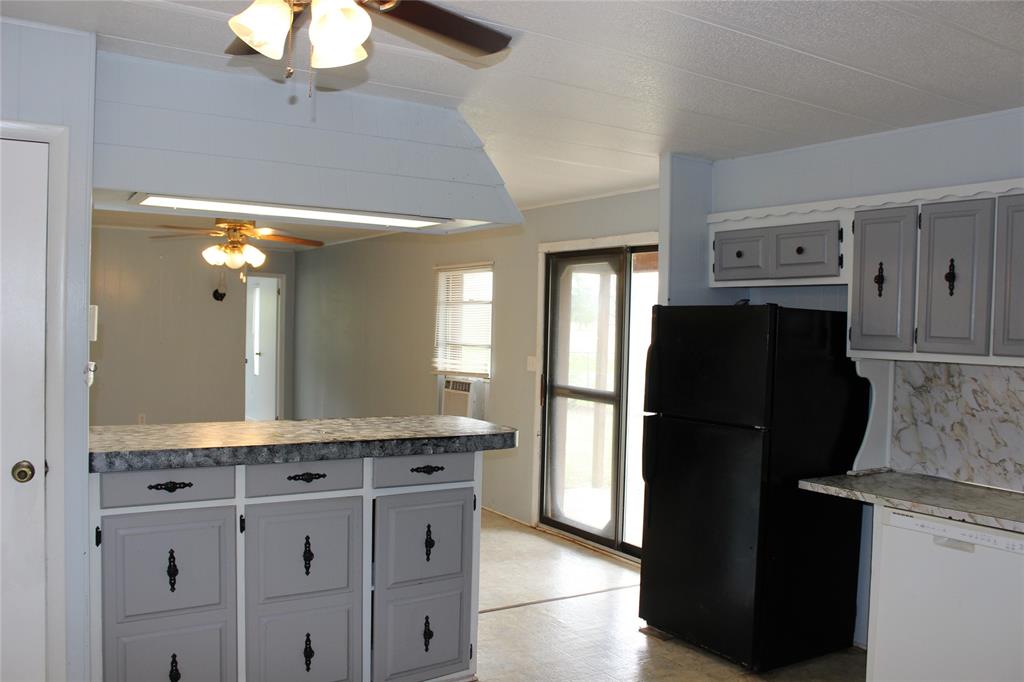3800 Dorcheat Road Minden, LA 71055 - Photo 28 of 40 a kitchen with granite countertop a refrigerator and a sink