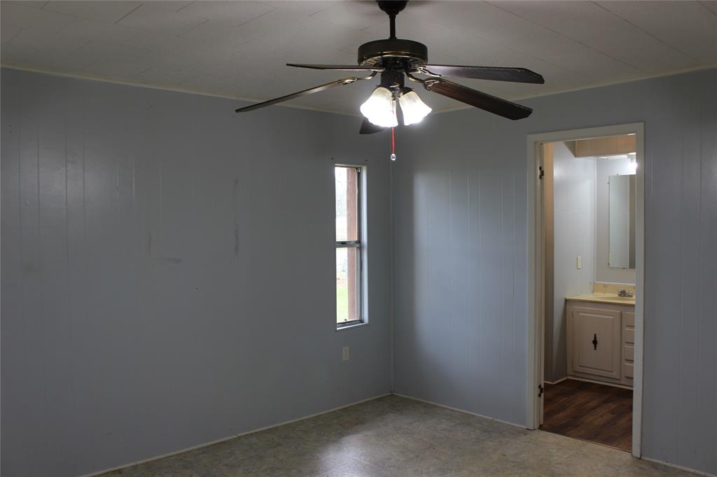 3800 Dorcheat Road Minden, LA 71055 - Photo 34 of 40 an empty room with a chandelier fan and windows