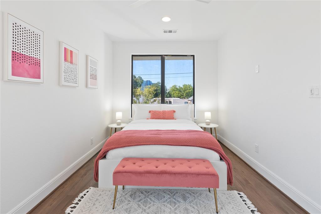 5014 Mission Avenue, Unit A Dallas, TX 75206 - Photo 14 of 26 a bed room with a bed and a painting on the wall