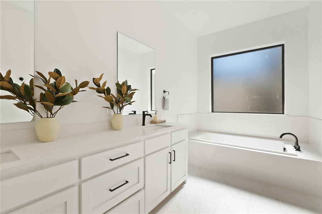 5014 Mission Avenue, Unit A Dallas, TX 75206 - Photo 16 of 26 a bathroom with a sink a mirror and a potted plant
