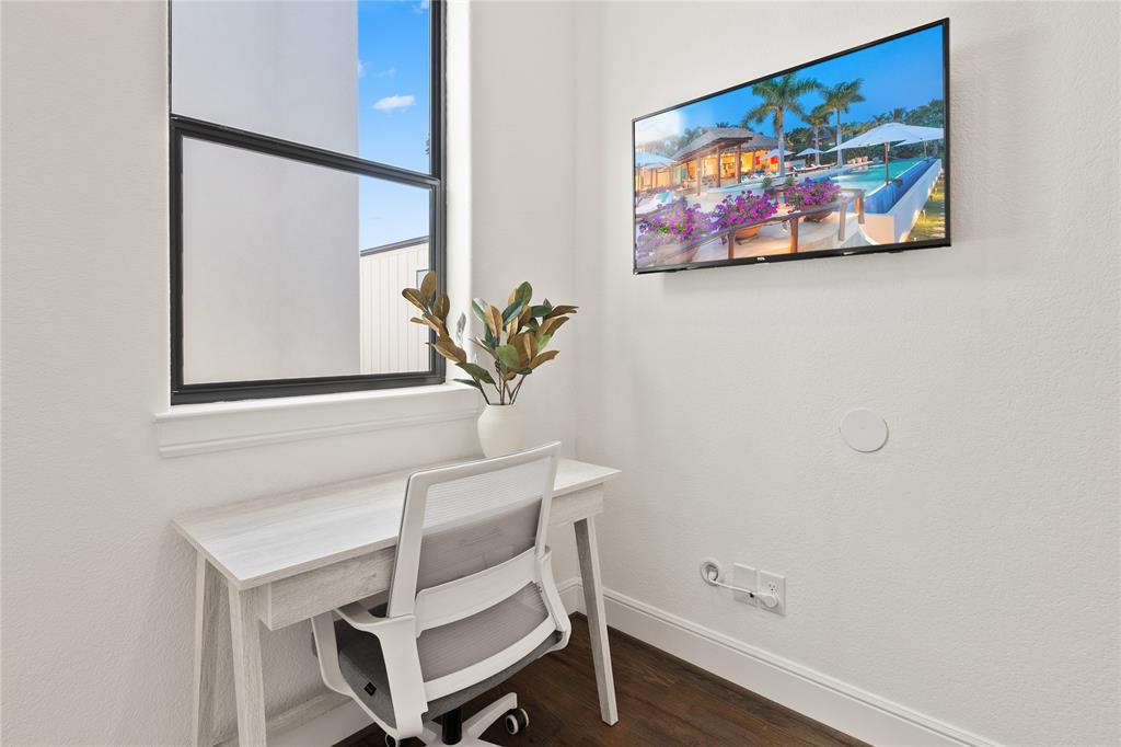 5014 Mission Avenue, Unit A Dallas, TX 75206 - Photo 19 of 26 a room with a table and paintings on the wall