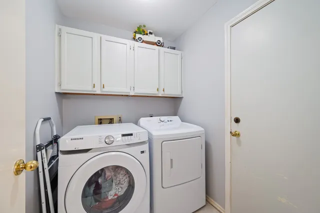 a view of storage and utility room with washer and dryer