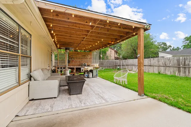 a view of a patio with couches chairs and a big yard
