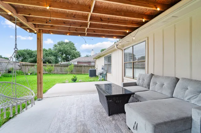 a view of a patio with couches and a big yard