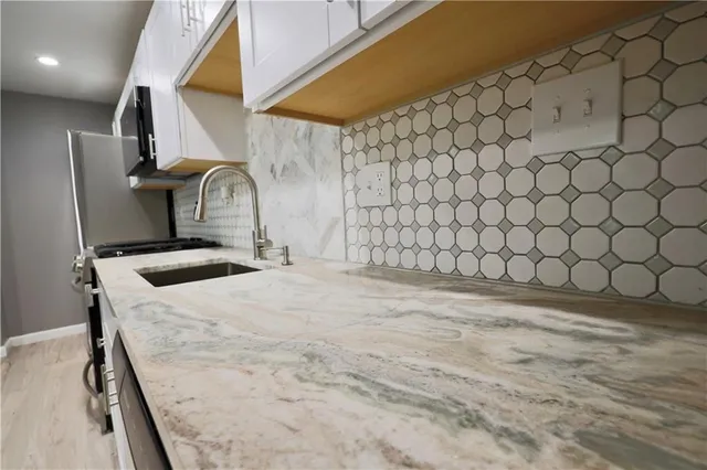 a view of a room with wooden floor