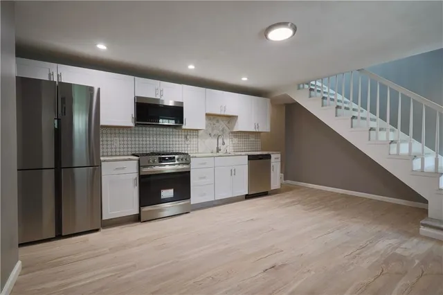a view of an entryway with wooden floor