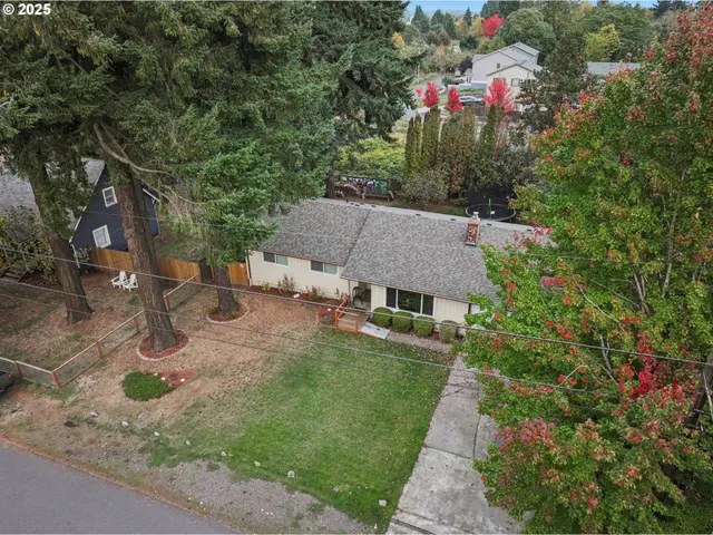 a view of a backyard with wooden fence