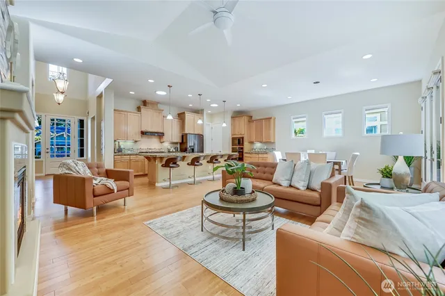 a living room with furniture and a view of kitchen