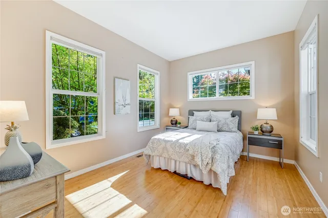 a bedroom with a bed and a large window
