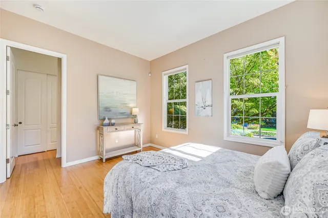 a bedroom with a bed and a large window