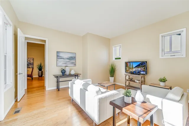 a living room with furniture a rug and a table