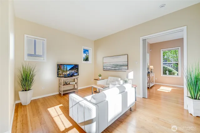 a living room with furniture and a potted plant