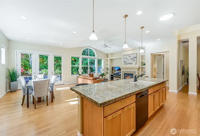 a view of center island of kitchen with granite countertop living room and living room