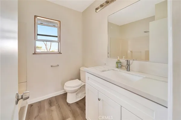 a bathroom with a sink toilet vanity and bathtub