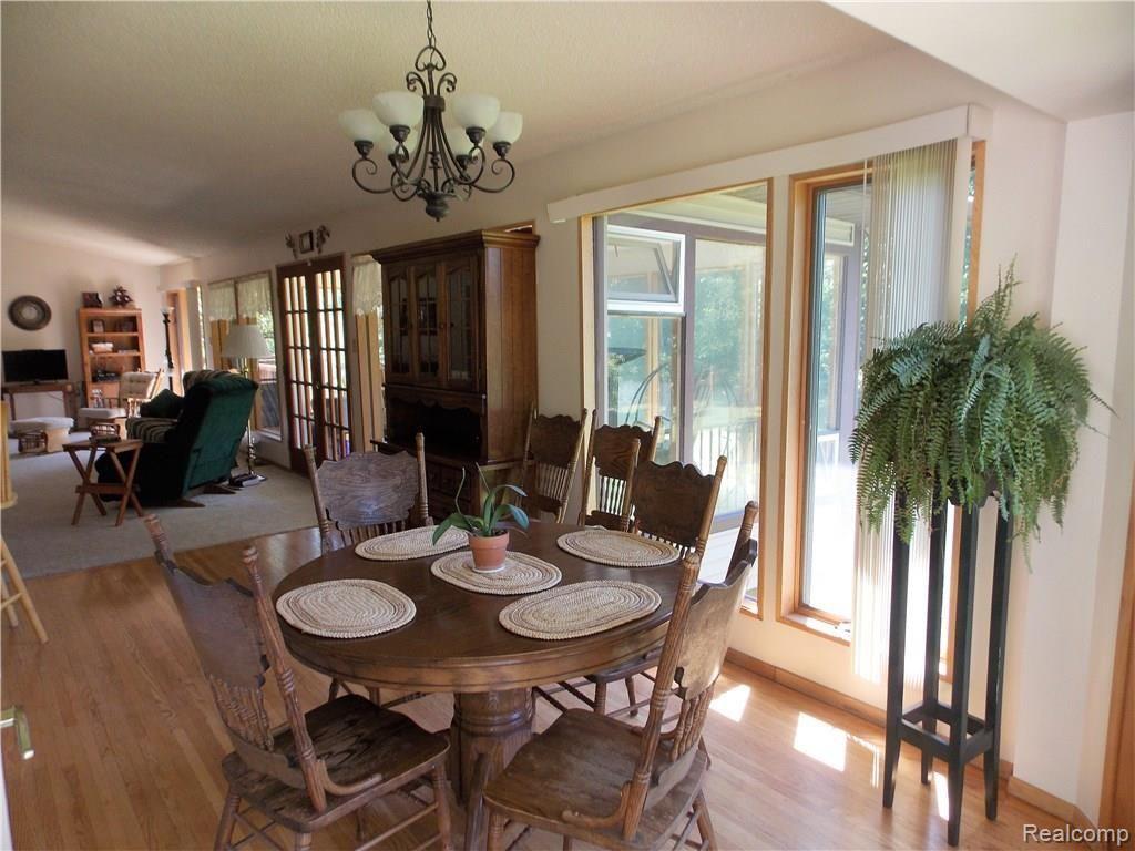 10221 Washburn Road Columbiaville, MI 48421 - Photo 11 of 37 As you enter the home from the west deck, you come into the Dining Room. The dining area is separated from living area only by the floor covering. The open design allows for even heat flows from the solarium.
