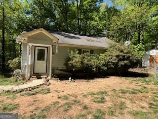 a view of a house with a yard covered in snow