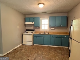 809 John W Breedlove Road Monroe, GA 30656 - Photo 8 of 11 a kitchen with granite countertop a refrigerator stove and sink
