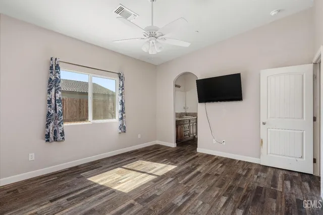 a view of a livingroom with wooden floor and a flat screen tv
