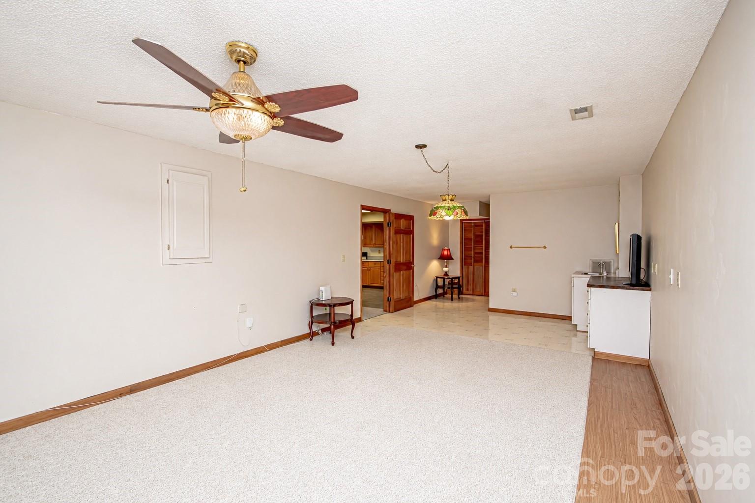 10801 Whitfield Ridge Drive Charlotte, NC 28277 - Photo 37 of 47 a view of a room with gym equipment and a chandelier