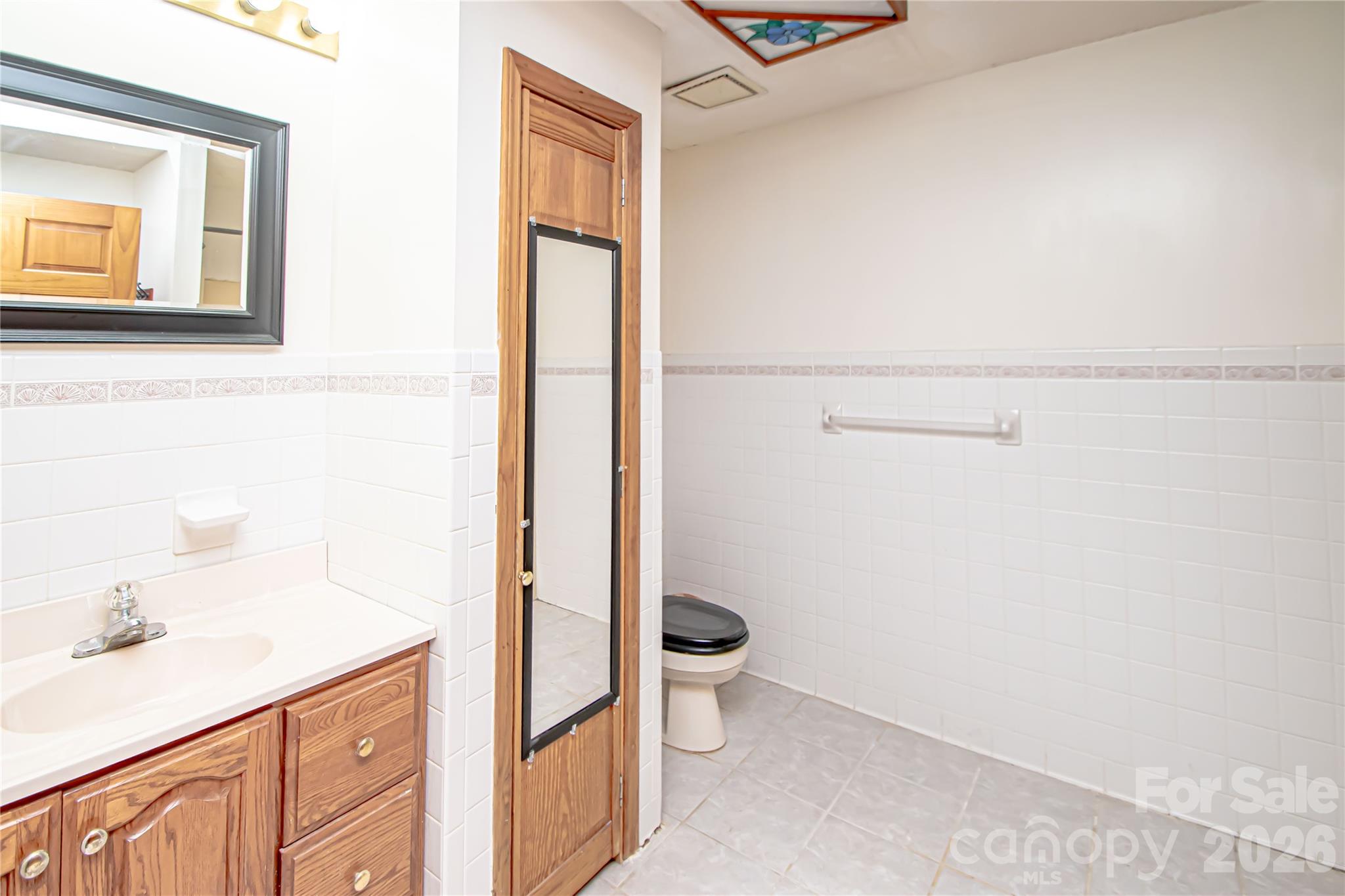 10801 Whitfield Ridge Drive Charlotte, NC 28277 - Photo 38 of 47 a bathroom with a granite countertop sink mirror and toilet