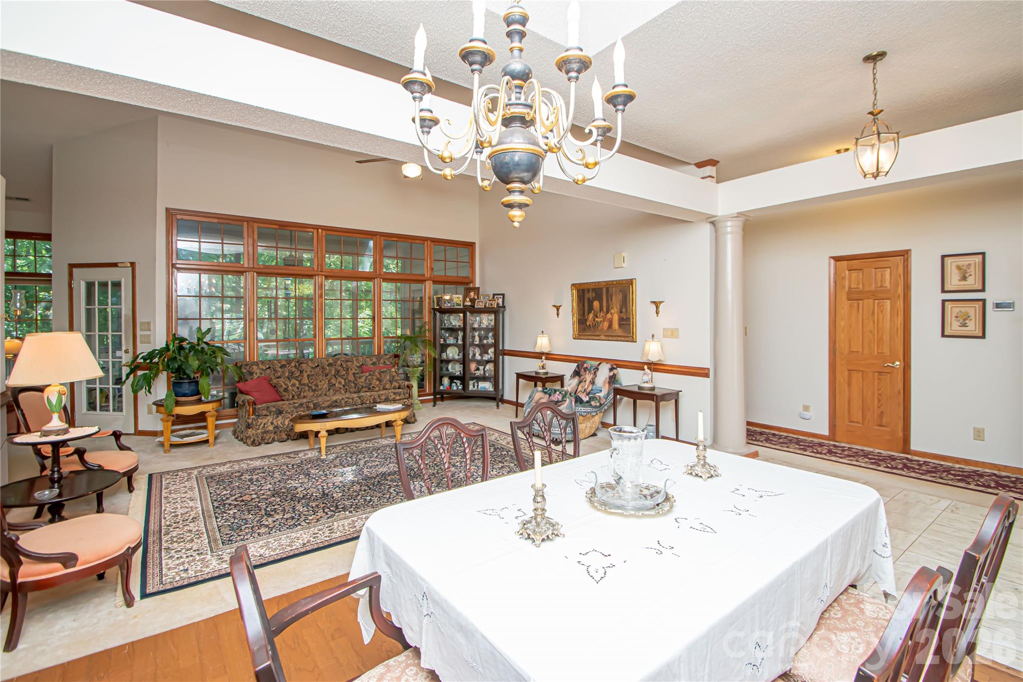 10801 Whitfield Ridge Drive Charlotte, NC 28277 - Photo 7 of 47 a view of a dining room with furniture a chandelier and large windows