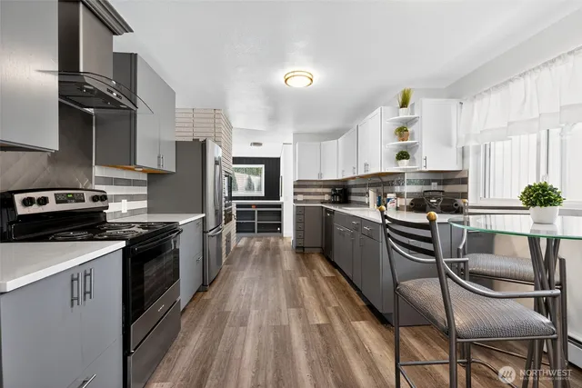 a kitchen with granite countertop stainless steel appliances cabinets a sink and a stove