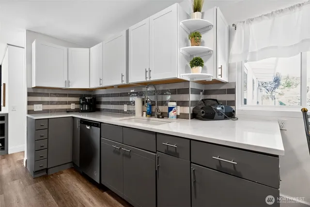 a kitchen with cabinets appliances and a window
