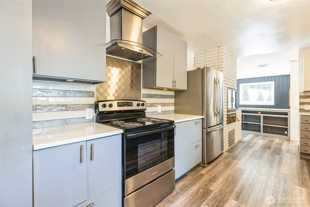 a kitchen with a stove and a refrigerator