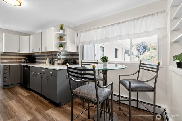a kitchen with a table chairs stove and cabinets
