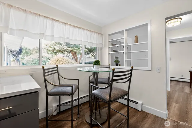 a dining room with furniture a rug and wooden floor