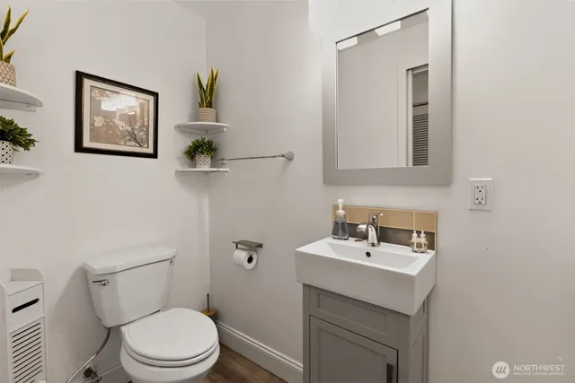a bathroom with a sink mirror and toilet