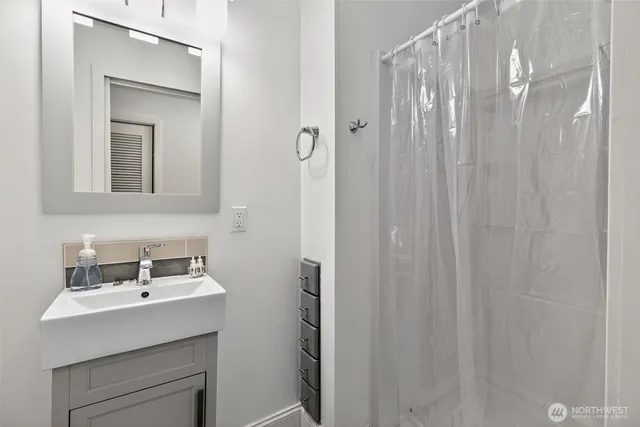 a bathroom with a sink a mirror and a vanity