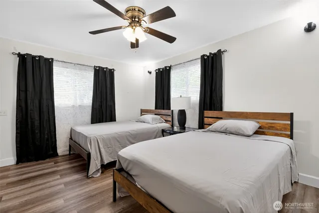 a bedroom with two beds and a chandelier