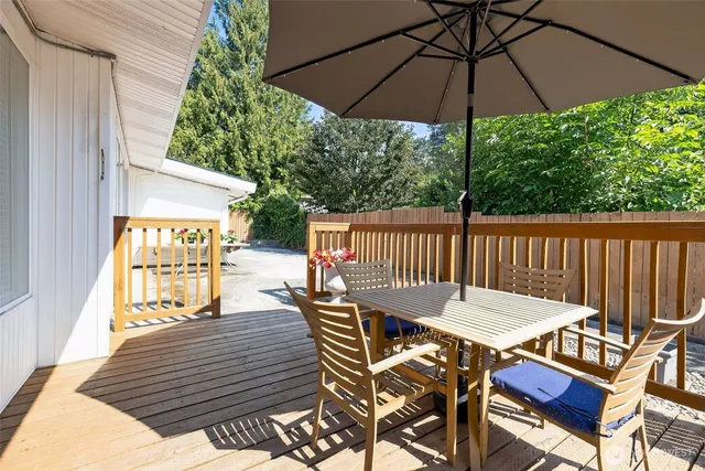 a view of a patio that has couches under an umbrella