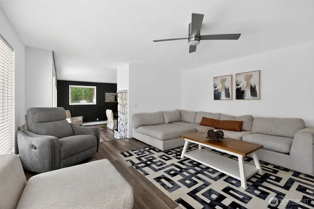 a living room with furniture a rug and a window