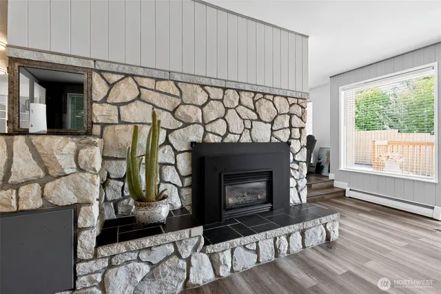 a living room with a fireplace with wooden floor