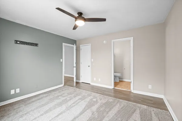 a view of a livingroom with a ceiling fan and window