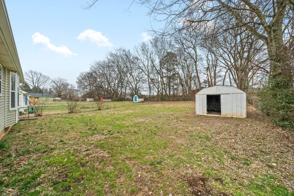 a backyard of a house with lots of green space