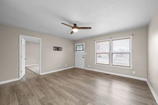 wooden floor in an empty room with a window