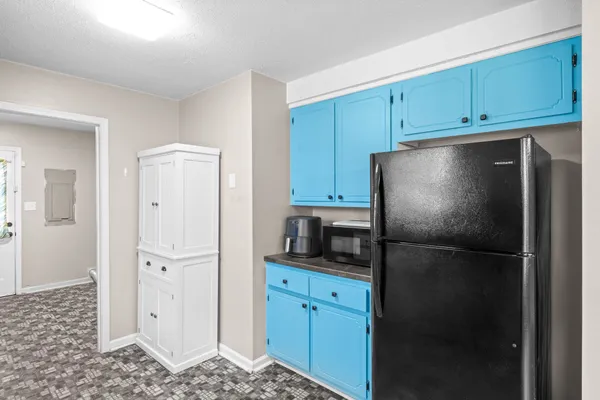 a kitchen with stainless steel appliances granite countertop a refrigerator and a stove