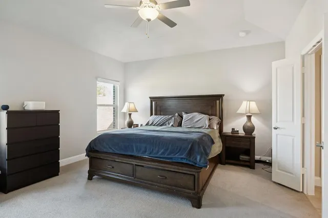a spacious bedroom with a bed and a chandelier