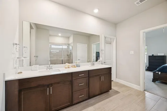 a bathroom with a double vanity sink and mirror