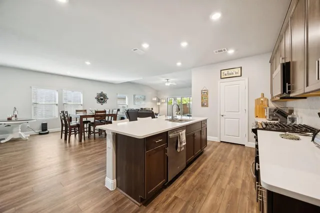 a kitchen with lots of counter top space and stainless steel appliances