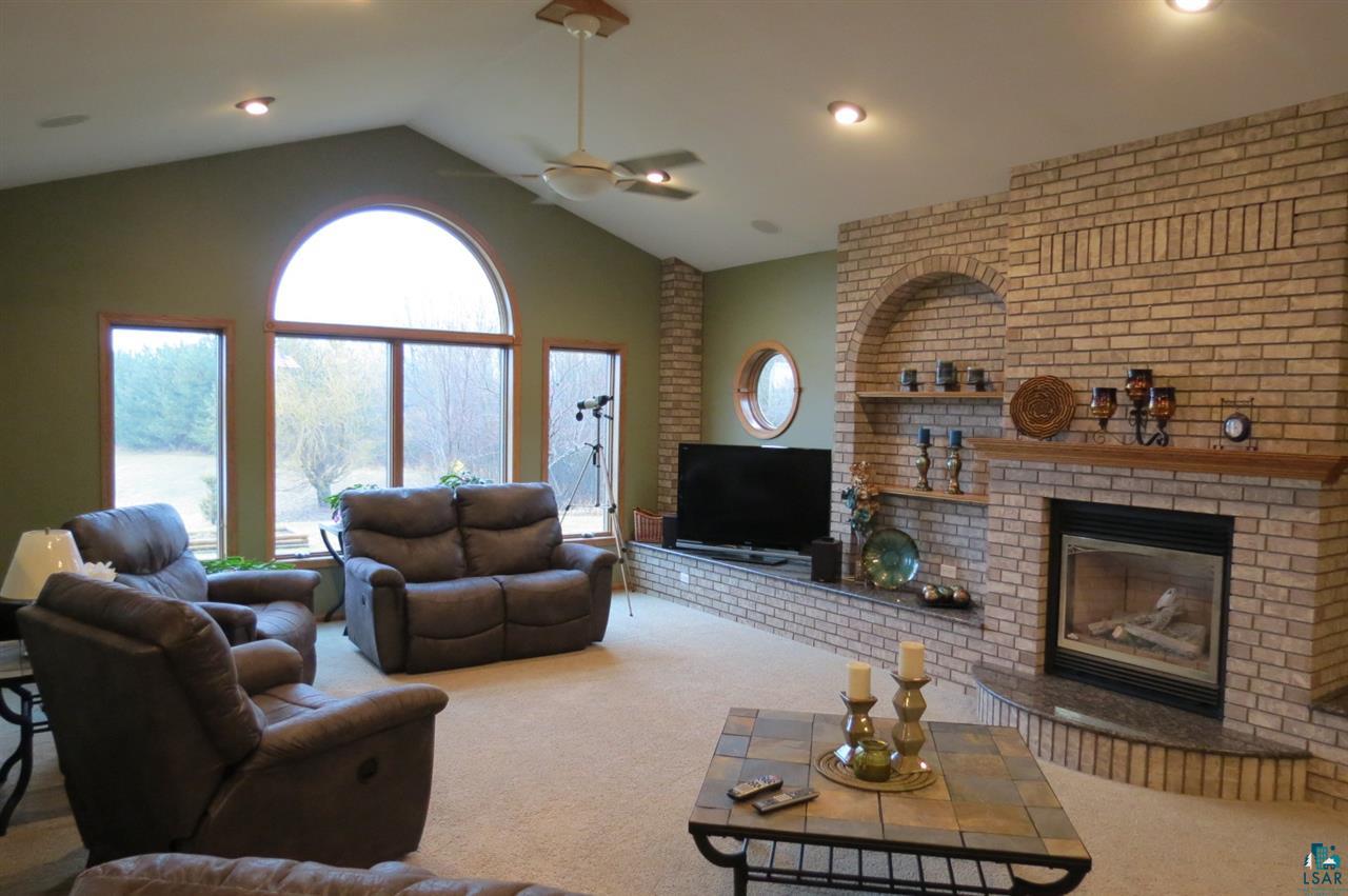 134 West Stark Road Esko, MN 55733 - Photo 8 of 24 Gas fireplace, vaulted ceiling, view to pond open
